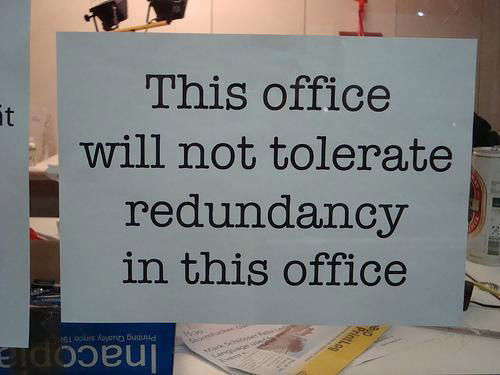 Sign that says “This office will not tolerate redundancy in this office”