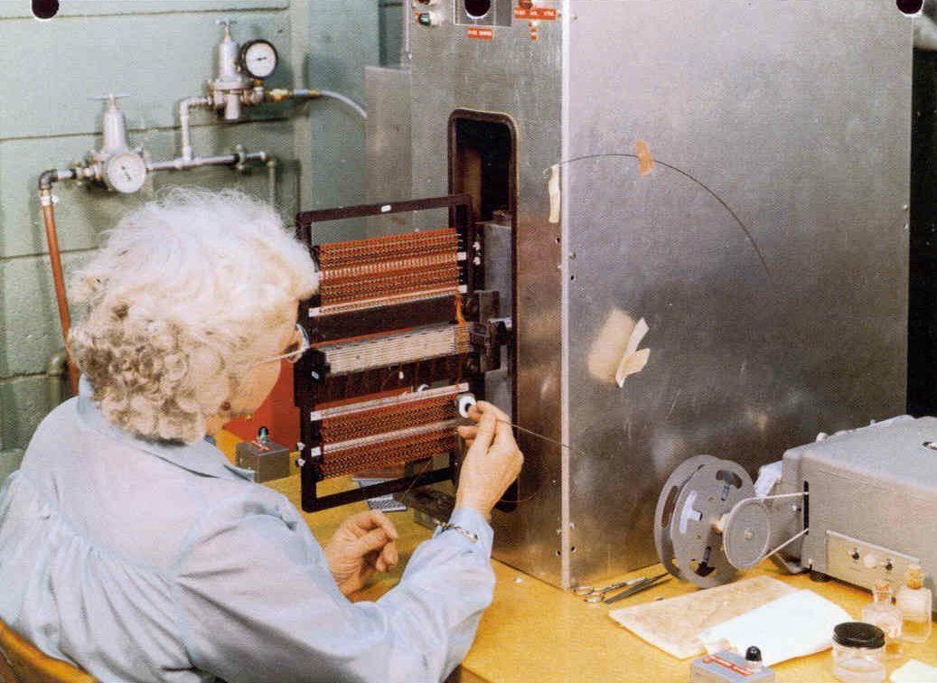 a woman weaves wire to create core rope memory