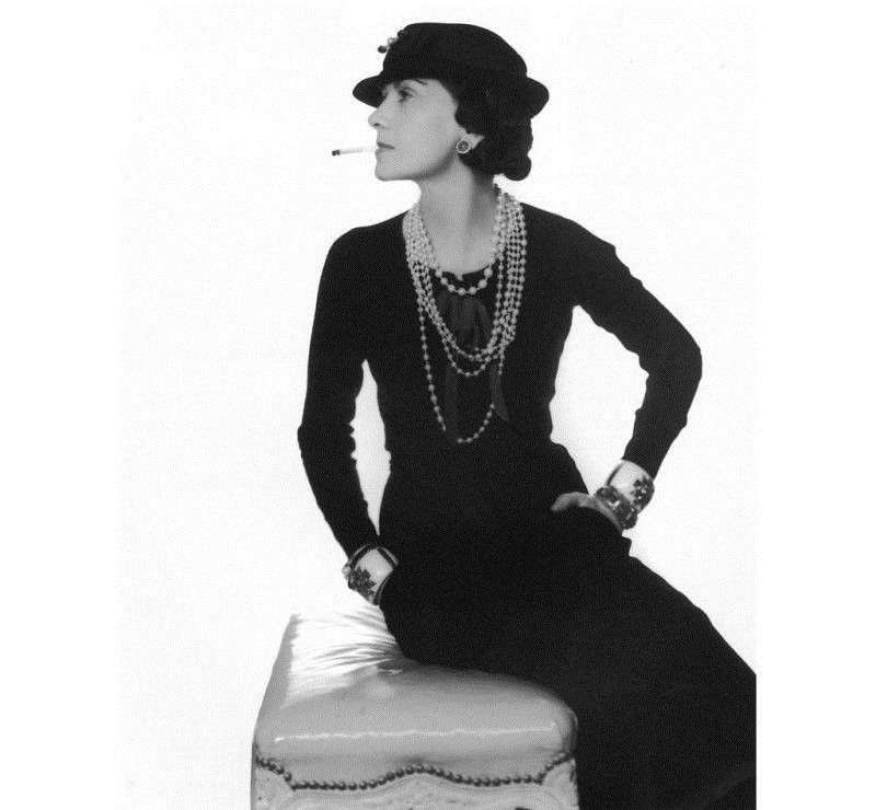 Chanel modeling the “little black dress”, an equally iconic and timeless design